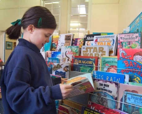 Student choosing a book at school